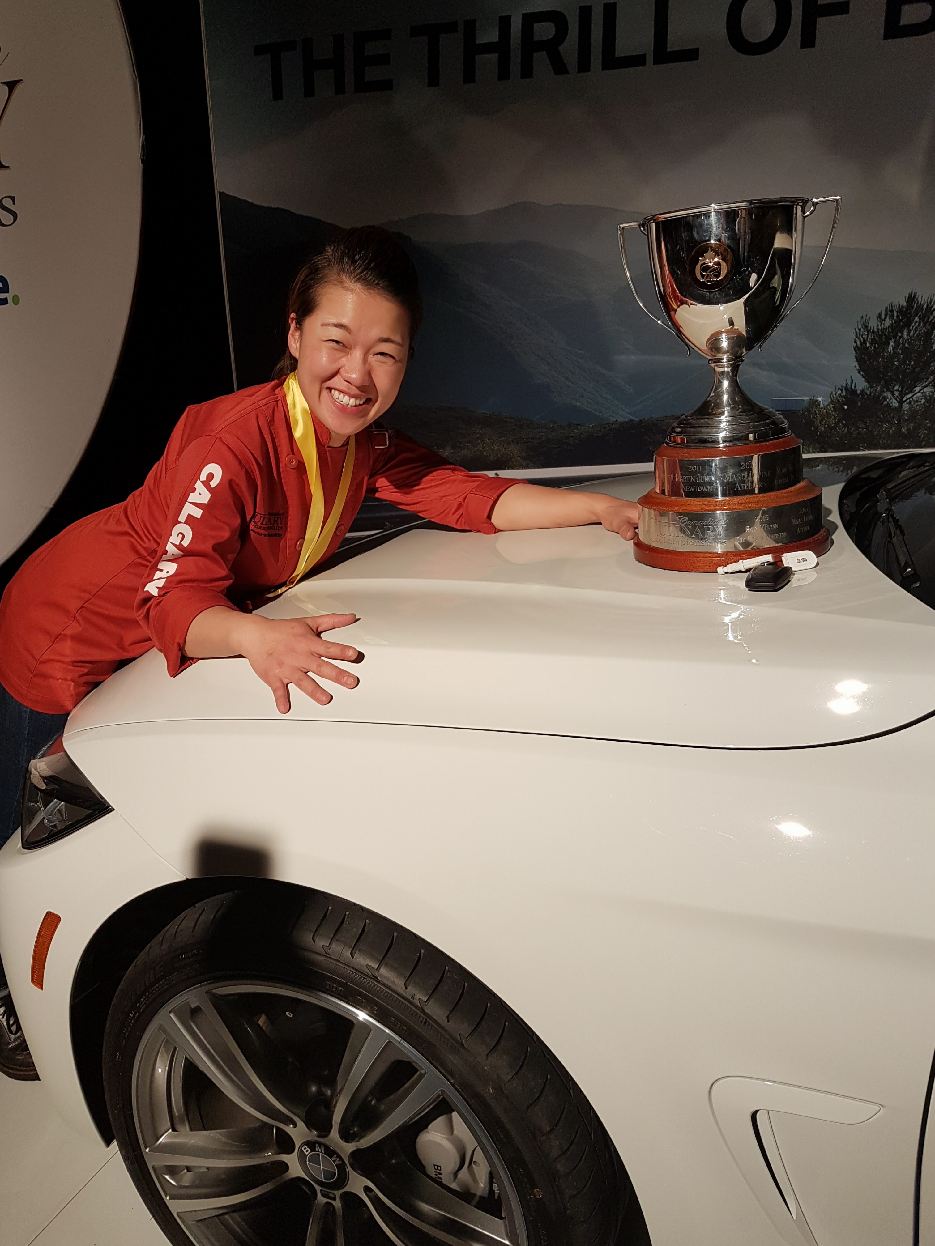The new Canadian Culinary Champion, Chef Jinhee Lee of Foreign Concept in Calgary, with her trophy and her prize - a new BMW